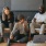 friends sit together around an open laptop