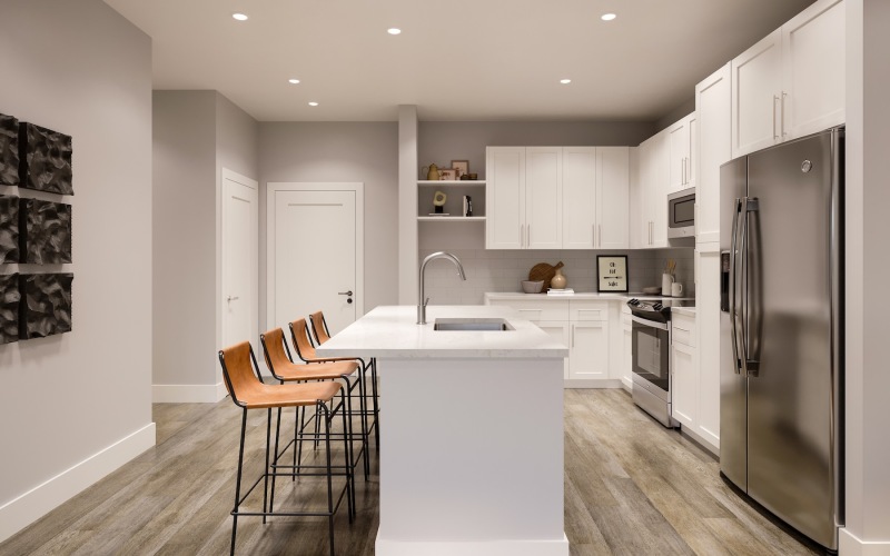 a kitchen with an island and chairs